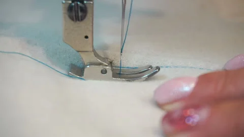 Professional sewing machine, middle-aged woman's hands Stock Footage 90377716