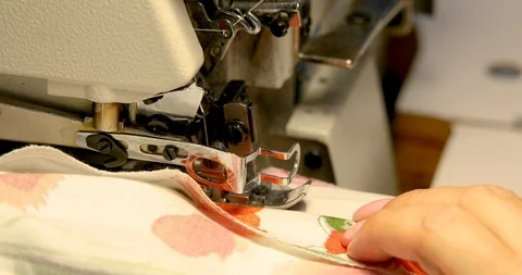 Professional sewing machine overlock with white fabric close-up Stock Footage 101979919