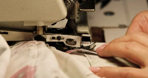 Professional sewing machine overlock with white fabric close-up Stockbeeldmateriaal 101980368