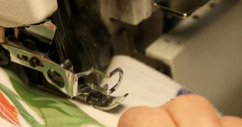 Professional sewing machine overlock with white fabric close-up Stock Footage 101981300