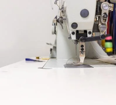 A professional sewing machine is in the workshop. Against the background of Stock Photos