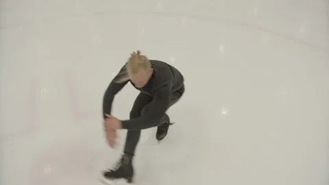 A professional skater performs a spin on ice Stock Footage 142264011