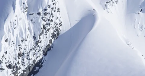 Professional skier cruising down remote powdery mountainside Stock Footage 111996740