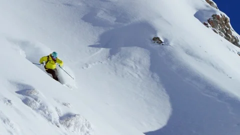 Professional skier making turns while skiing down the snowy mountain slope Stock Footage 116740196
