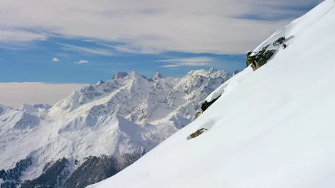 Professional skier making turns while skiing down the snowy mountain slope Video stock 116741408