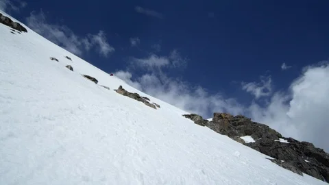 Professional skier making turns while skiing down the snowy mountain slope Stock Footage 116743802
