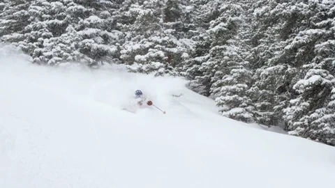 Professional skier making turns while skiing on snowy mountain slope Stock Footage 116785743