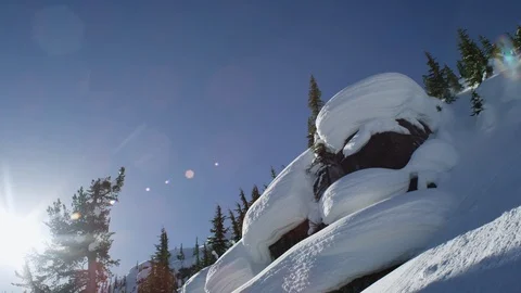 Professional skier performing grab trick while jumping from snowy mountain cliff Stock Footage 116784701