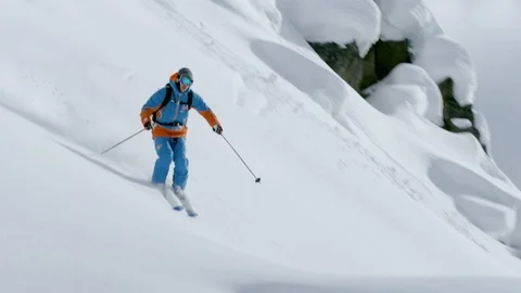 Professional skier performs a backflip while skiing on snow covered mountain Stock Footage 116631375