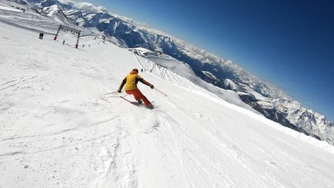 Professional Skier Performs the Carving Technique on a Wide Slope Stock Footage 105424310