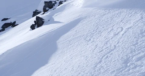 Professional skier shredding down a remote powdery mountainside Stock Footage 111997275