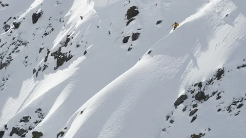Professional skier speeding down powdery mountain slope Stock Footage 113216950
