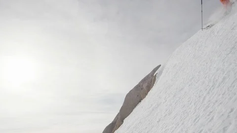 Professional skier speeding down the ridge of a remote mountain Stock Footage 113218209