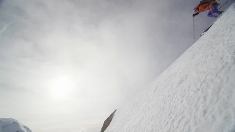 Professional skier speeding down the ridge of a remote mountain Stock Footage 113218307