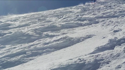 Professional skier tearing through deep snow on a remote mountain Stock Footage 113203598