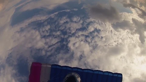 Professional skydiver in helmet parachuting in cloudy sky. Flight. Sport. Speed Video stock 79513312