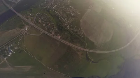 Professional skydiver parachuting above green flatland. River. Landscape. Height Stockbeeldmateriaal 66654853