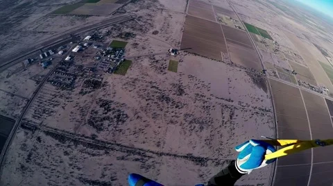 Professional skydiver parachuting in blue sky above Arizona. Sandy country Video stock 65674749