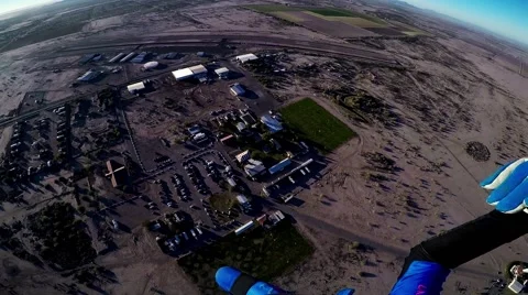 Professional skydiver parachuting in blue sky above Arizona. Sunny evening Stock Footage 65676438