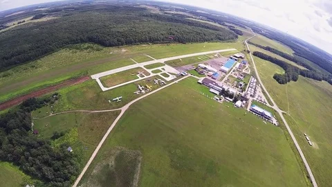 Professional skydiver parachuting, fly down to green field in sunny day. Nature Stock Footage 70532867