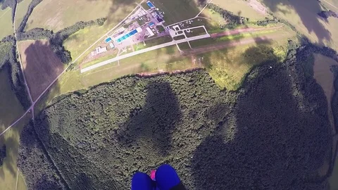 Professional skydiver parachuting, fly over green forest in sunny day. Landscape Stock Footage 70532839