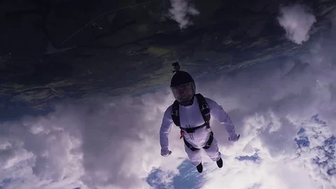 Professional skydivers fly in cloudy sky. Sunny day. Team. Flight. Parachuting Видео 70532639