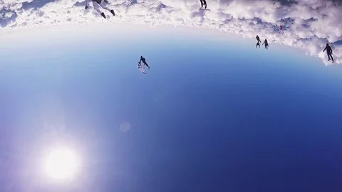 Professional skydivers parachuting, make formation in air in sunny day. Clouds Video stock 70533087