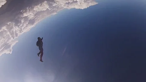 Professional skydivers in uniform free falling in sky. Opening parachute. Speed. Video stock 79513429