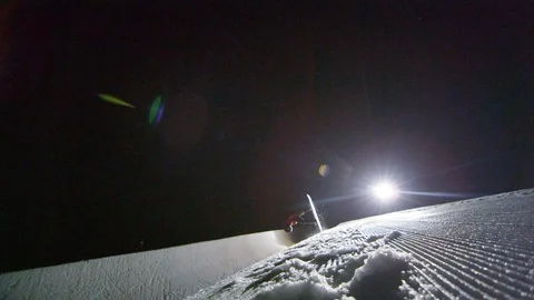 Professional snowboarder performs a flip on half pipe at night Stock Footage 116786535