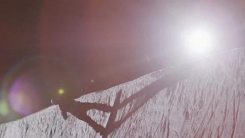 Professional snowboarder performs a flip in slow motion on half pipe at night Stock Footage 116786575