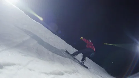 Professional snowboarder shreds half pipe at night Stock Footage 116786314