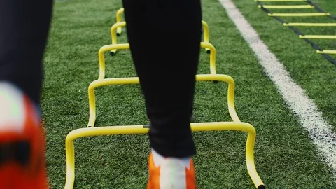 Professional soccer player with agility training hurdles. 4k slow motion Stock Footage 101097002