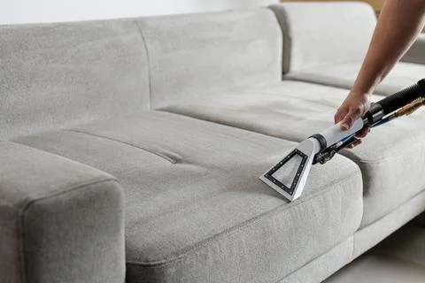 Professional sofa cleaning with extraction vacuum removing dirt from uphols.. Stock Photos