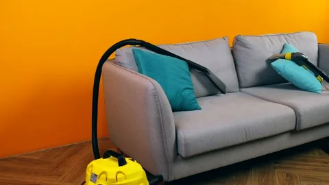 Professional Sofa Cleaning Service Using Vacuum Cleaner Stock Footage 146990776