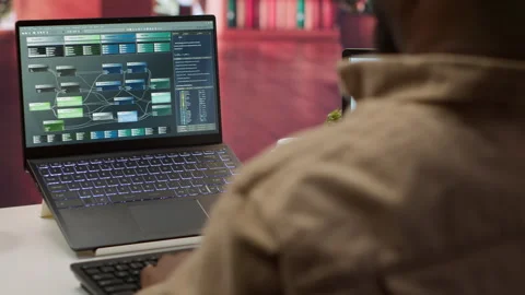 Professional software developer at desk working on AI coding Stock Footage 277827839