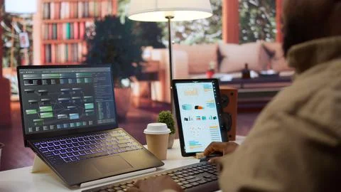 Professional software developer at desk working on AI coding Stock Photos