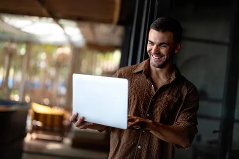 Professional software developer reviewing code on a laptop in a bright work.. Фото