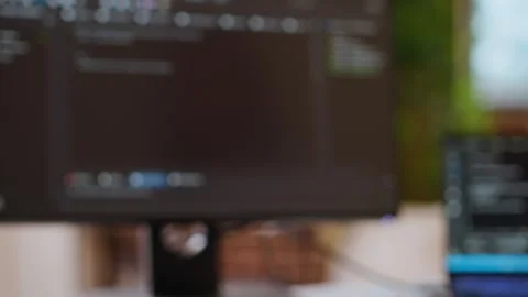 Professional software developer types code on a laptop in a sleek workspace Stock Footage 319713150