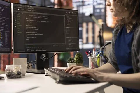 Professional software developer types code on a laptop in a sleek workspace Stock Photos