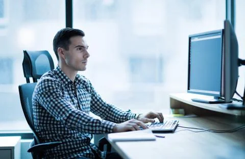 Professional software developer working in office Stock Photos