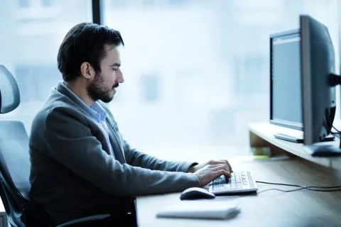 Professional software developer working in office Stock Photos