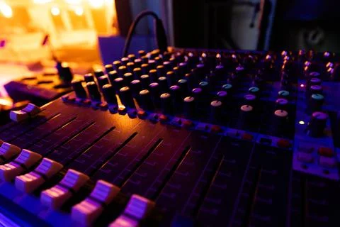 Professional Sound Mixer Console with Dynamic Blue and Orange Stage Lighting Stock Photos
