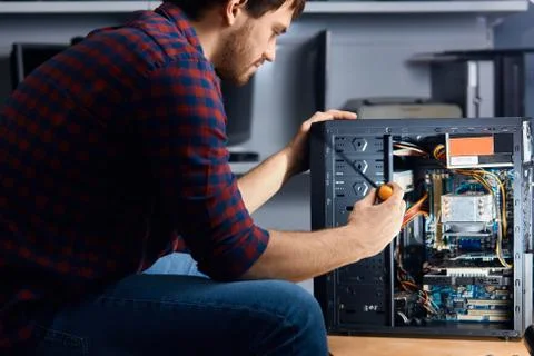 Professional staff disassembling and cleaning your old computer Stock Photos