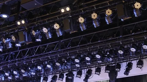 Professional stage lights on ceiling truss suddenly turning on Stock Footage 346354300