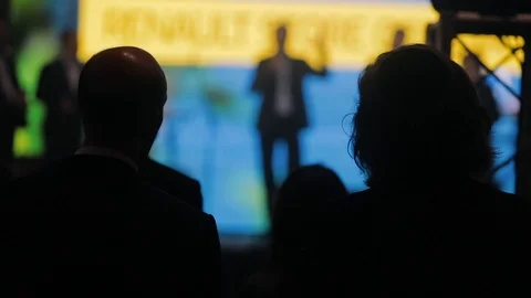 Professional stage speaker in silhouette of a group of people Stock Footage