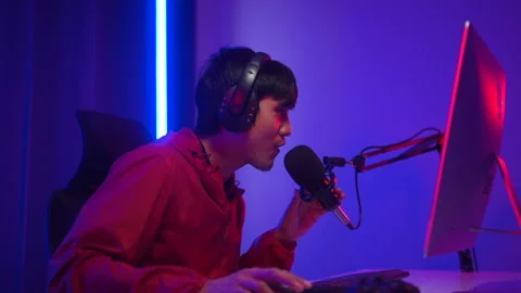 Professional Streamer gaming playing game online in dark room neon light. Gamer. Stock Footage 235653974