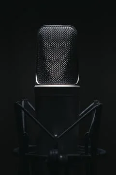 A professional studio microphone captured in moody low-key lighting, perfec.. Stock Photos