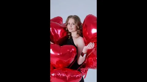 Professional studio portrait featuring elegant woman in black dress, smiling and Stock Photos