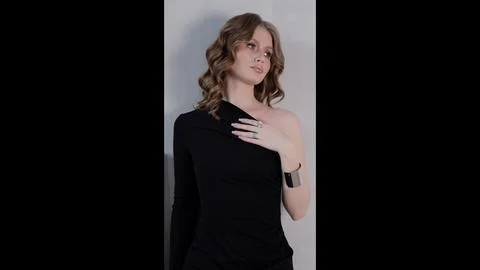 Professional studio portrait featuring young woman with flowing waves, sporting Stock Photos