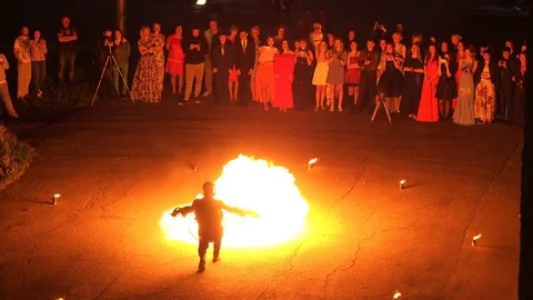 Professional stuntman produces a flame of fire from fire guns Stock Footage